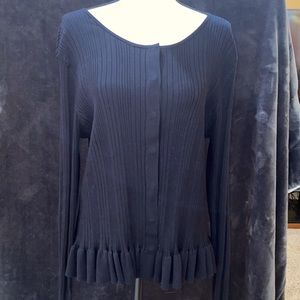 Cabi cardigan is ribbed and has subtle ruffles.